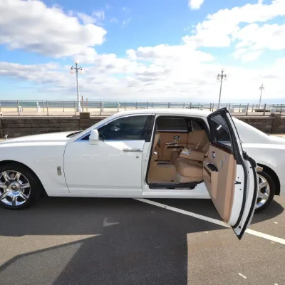 white rolls-royce ghost with door open