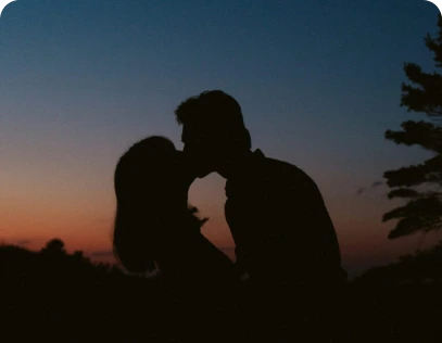 Couple enjoying luxury limousine service during a romantic sunset date.